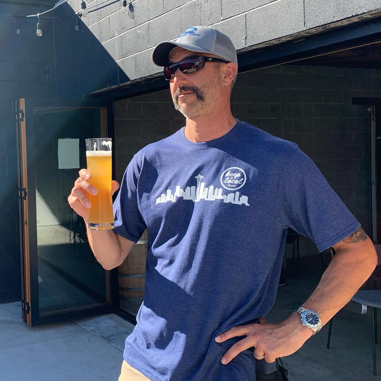 Stylish gentleman with a mustache, craft brew, and a Limited Edition Keep It Local Seattle T-Shirt